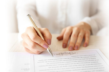 Woman signing a contract